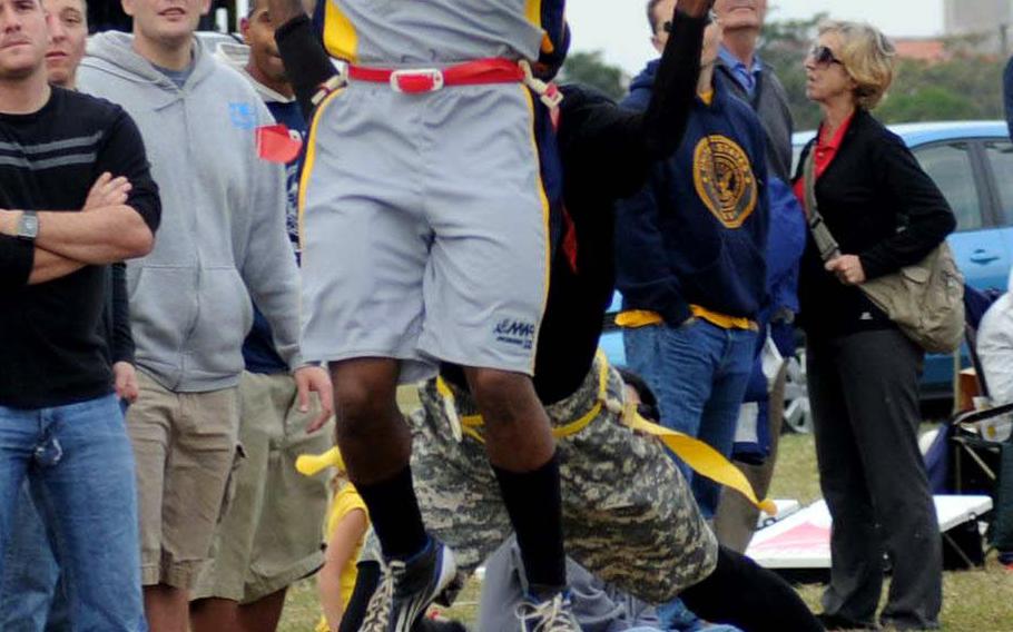 Navy receiver Damar Powell-Davis tries to get a handle on the ball during Saturday's 24th Army-Navy flag-football rivalry game at Torii Station, Okinawa. Army rallied to win 27-15.