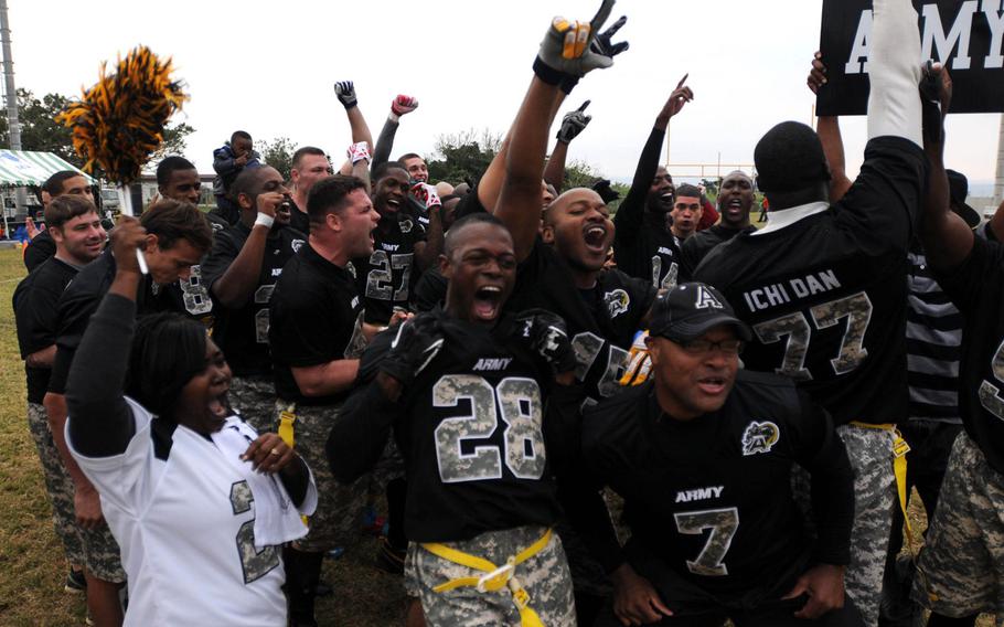 Army players, coaches and supporters cheer their victory in Saturday's 24th Army-Navy flag-football rivalry game at Torii Station, Okinawa. Army rallied to win 27-15.