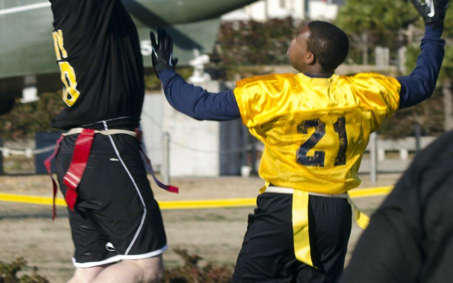 Army tight end Derek Wolske pulls in a high pass on an extra-point attempt to seemingly tie the game 13-13 during the annual Army-Navy flag football game Saturday at Naval Air Facility Atsugi, Japan. Despite having two hands on the ball and planting both feet inbounds, the pass was ruled incomplete, leaving the score 13-12 Navy, which would be the final.