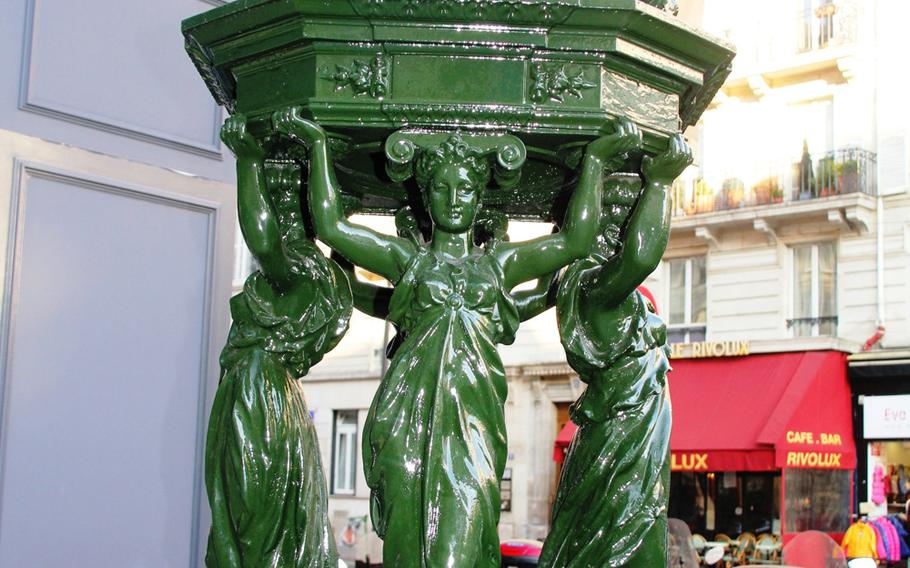 An ornate cast-iron Wallace fountain in the Marais district of Paris. Richard Wallace, an Englishman, gave Paris money in the 19th century to erect the water fountains across the city. The fountains were designed by sculptor Charles-Auguste Lebourg.
