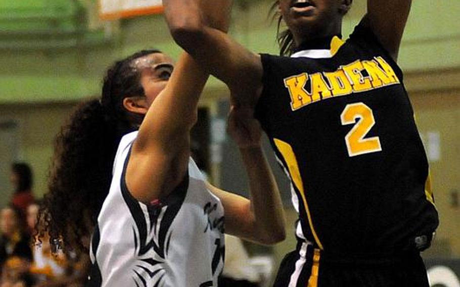 Kadena's Jasmine Rhodes shoots past Kubasaki's Ameyna Saunders-Jackson in a December matchup. The two teams take on adults this weekend in a Martin Luther King Day tournament in Okinawa.