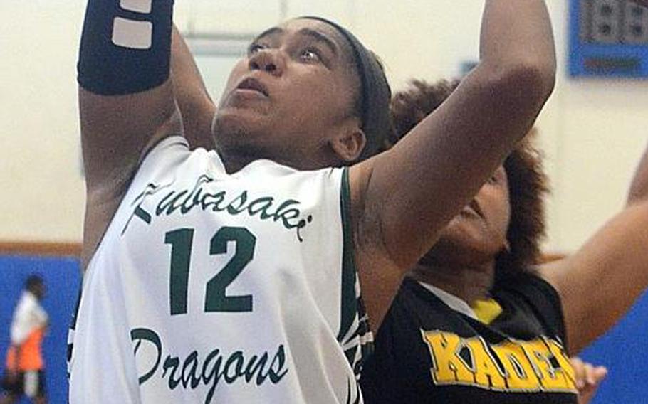 Kubasaki guard Sydney Johnson, shown shooting in front of Kadena's Montaya Jones during the 8th Okinawa-American Friendship Basketball Tournament, said she'd grown tired of what she termed the losing culture of Dragons girls basketball in her first three seasons, and is trying to help the team turn the corner onto a winning path.