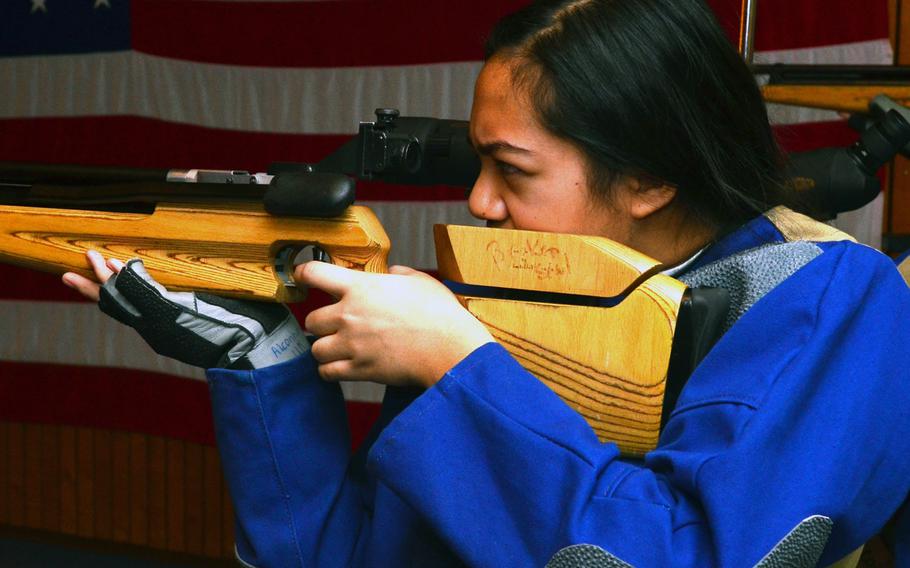 Moani DeGuzman, team captain for Alconbury's marksmanship team, takes aim at her target at the DODDS-Europe marksmanship competition in Wiesbaden, Germany, Jan 11, 2014. The Alconbury marksmen travelled to Germany for the meet but often shoot at their home range and submit scores to compare with those of their opponents in what is known as 'postal' competition.