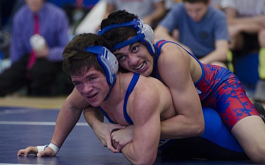 Ramstein's Andres Rios holds onto Aaron Norton of Brussels during a 138-pound match at Brussels on Saturday, Feb. 8, 2014. Rios would go on to win the weight bracket and Norton would take third.

Adam L. Mathis/Stars and Stripes