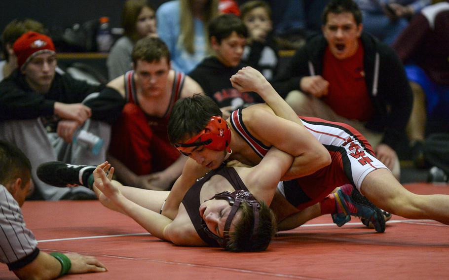 Kaiserslautern's Matt Fischer sinks into Baumholder's Terence Wilson moments before pinning him to win the 120-pound weight class at the Central Sectional Wrestling Championships at Kaiserslautern, Germany, Saturday, Feb. 8, 2014.
