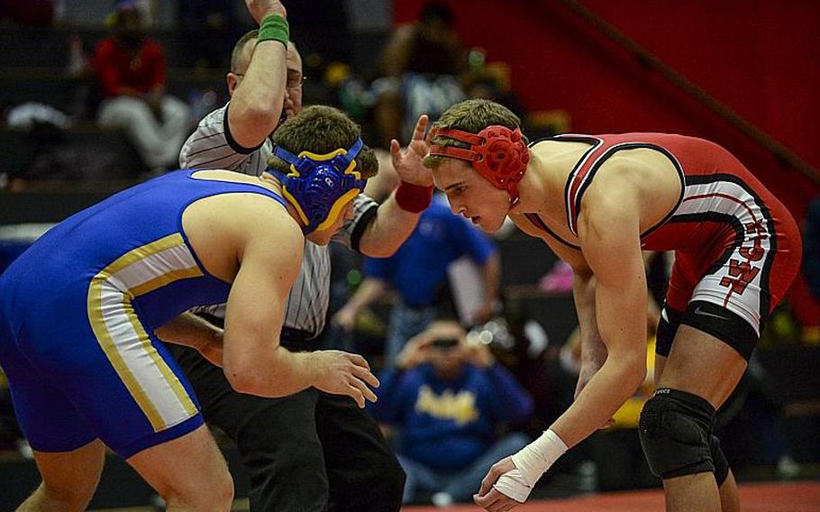Kaiserslautern's Arvin Hrushka, right, and Wiesbaden's Brett Wisti start the 170-pound championship match in the Central Sectional Wrestling Championships at Kaiserslautern, Germany, Saturday, Feb. 8, 2014. Hrushka went on to defeat Wisti.
