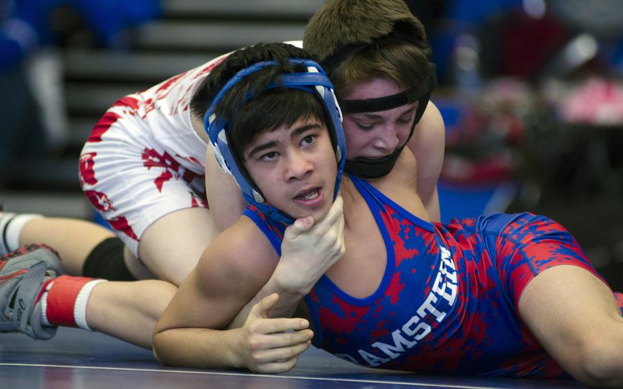 Grant Barkhurst with Lakenheath grapples with Stan Cruz with Ramstein during a 106-pound match for first place at Brussels American School on Saturday, Feb. 8, 2014. Both wrestlers earned a spot at this weekend's European Championships in Wiesbaden, Germany.

Adam L. Mathis/Stars and Stripes