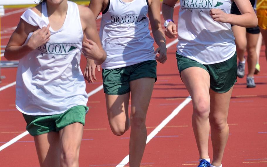 Zoe Jarvis, a freshman shown leading senior teammates Sam Fugate and Jessica Freedman, is a distance runner and 3,200-meter specialist for the Kubasaki Dragons