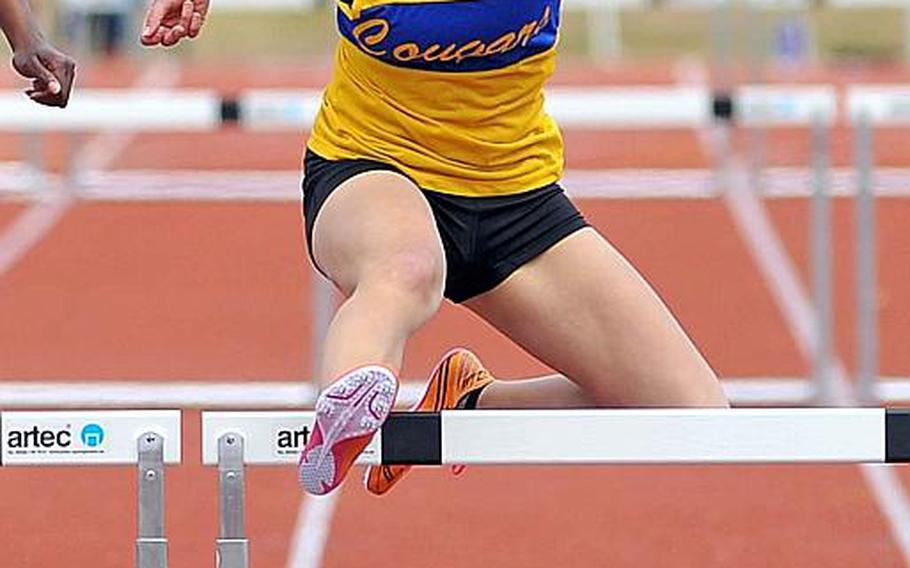 Ansbach's Mykala Bazen clears the last hurdle in the 300-meter hurdle race at the DODDS-Europe track and field championships last year to win in 47.96 seconds. Bazen will be returning for the Cougars when the 2014 season gets under way this weekend.
