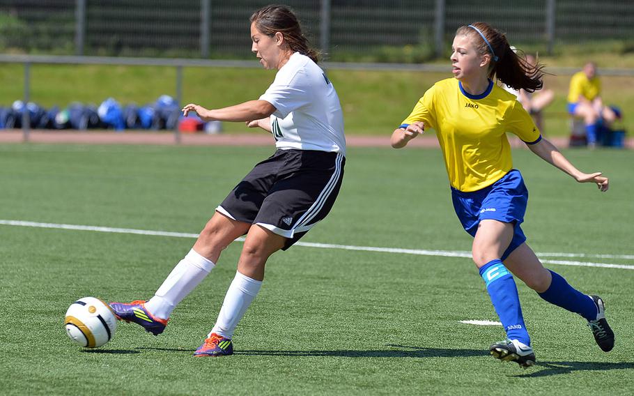 Desirae Carpenter of Naples, left, gets away from Ansbach's Delaney Dickey for a shot on goal in a opening day Division II match at the DODDS-Europe soccer championships in Landstuhl, Germany, Monday, May 19, 2014. Naples won 6-0.