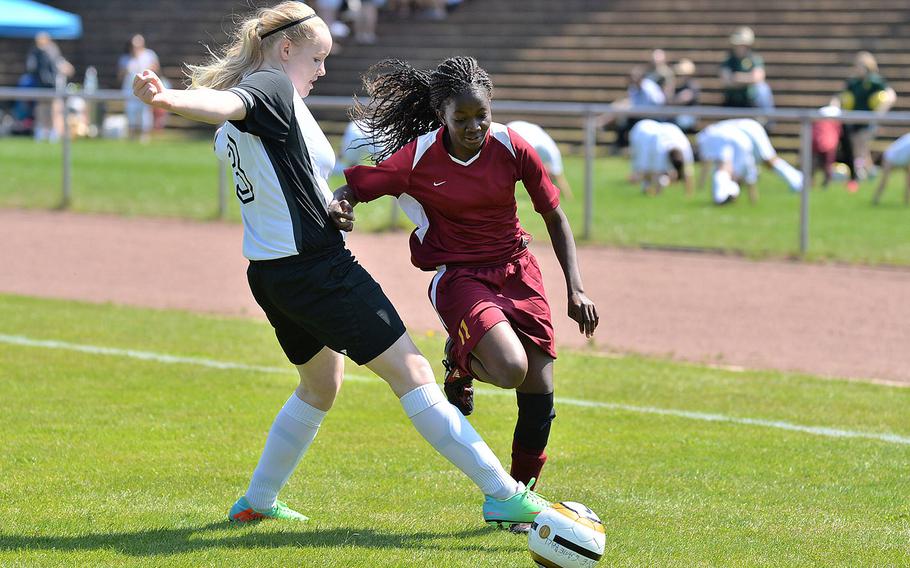 AFNORTH's Mariell Prestmo, left, clears the ball in front of Baumholder's Abena Agyapomaa in an opening day Division II match at the DODDS-Europe soccer championships in Landstuhl, Germany, Monday, May 19, 2014. AFNORTH won 2-0.