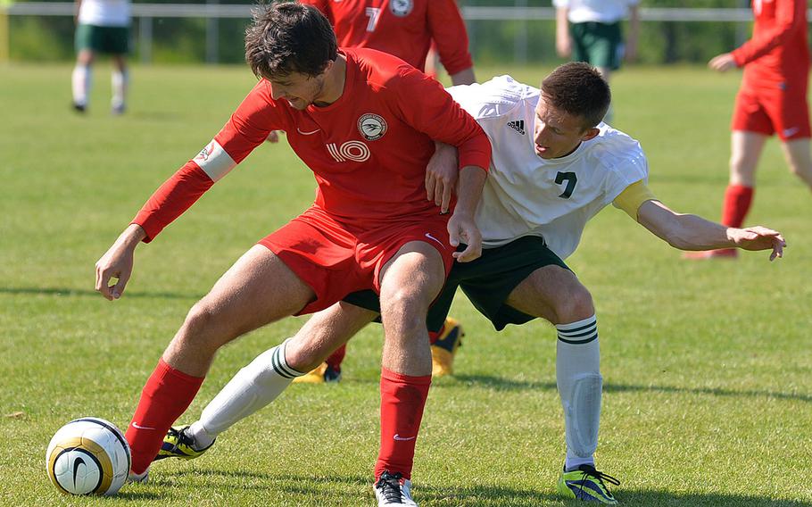 American Overseas School of Rome's Lamberto Lambertini, left, and SHAPE's Adrian Domijan fight for a ball in their opening day Division II match at the DODDS-Europe soccer championships in Reichenbach, Germany, Monday, May 19, 2014. The game ended in a 1-1 tie.