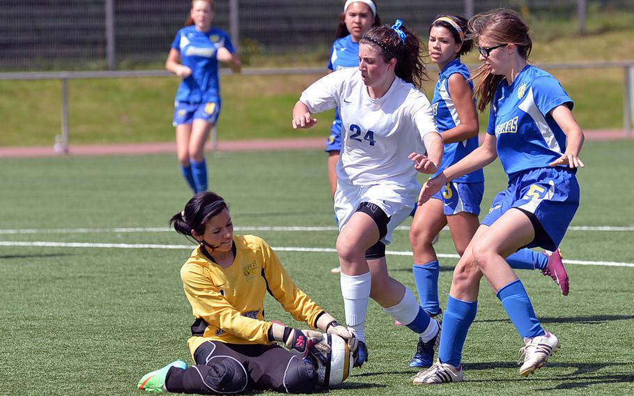 Sigonella keeper Julia Harley gets to the ball before Alexandra DeFazio of Brussels in a Division III match at the DODDS-Europe soccer championships at Landstuhl, Germany, Tuesday, May 20, 2014. Brussels won 3-2. At right is Sigonella's Aidan Adrano.
