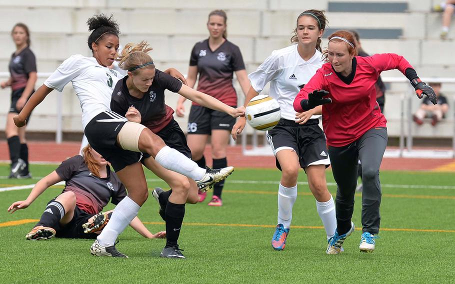 Amillia Espiet of Naples gets off a shot despite the pressure of AFNORTH's Hope BonenClark in the Division II final at the DODDS-Europe soccer championships in Kaiserslautern, Germany, Thursday, May 22, 2014. Naples won 2-0. At right are Kayte Cairns of Naples and AFNORTH keeper Danielle Cunningham.