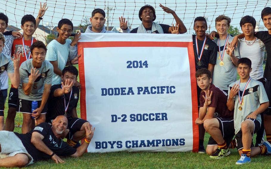 Matthew C. Perry players celebrate with the banner for the third straight year and fourth in five years following their 3-1 win in Thursday's Far East Boys Division II Soccer Tournament final.