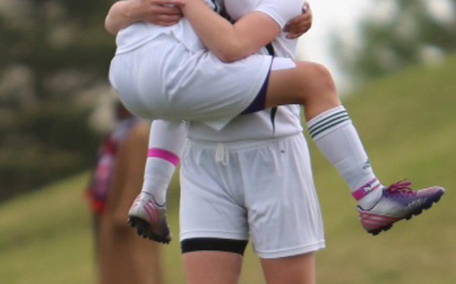 Robert D. Edgren's Vanessa Black leaps into the arms of teammate Marry Mattingly after scoring a goal in Thursday's Far East Girls Division II Soccer Tournament final, won by Edgren 3-1, the first girls soccer title in school history. Black would be named offensive Most Valuable Player.
