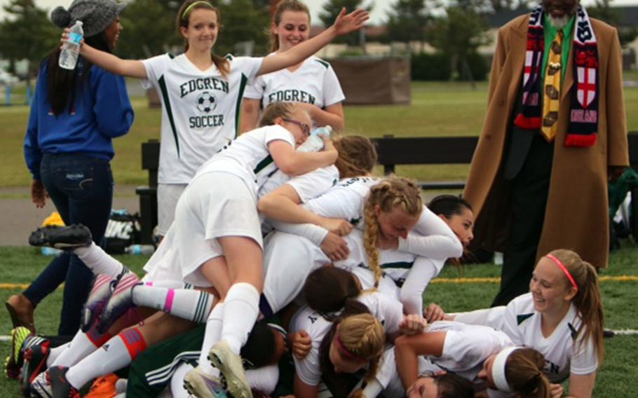 Robert D. Edgren Eagles girls soccer players pile on each other following Thursday's Far East Division II Tournament final, won by Edgren 3-1, the first girls soccer title in school history.