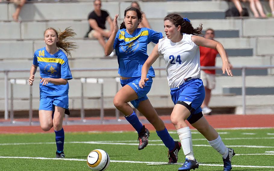 Chased by Florence's Malaika Handa, left, Alexandra DeFazio of Brussels heads up the field on her way to scoring the winning goal in the Division III title game at the DODDS-Europe soccer championships in Kaiserslautern, Germany, Thursday, May 22, 2014. Brussels won 1-0.