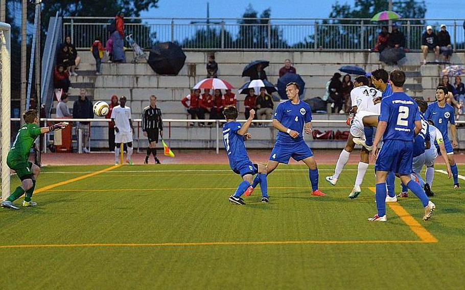 Ramstein and Kaiserslautern players watch as Francisco Gonzales' header bounces past Ramstein keeper Cameron Fralick and into the goal in the Division I final at the DODDS-Europe soccer championships in Kaiserslautern, Germany, Thursday, May 22, 2014. Ramstein won an exciting game 4-3.