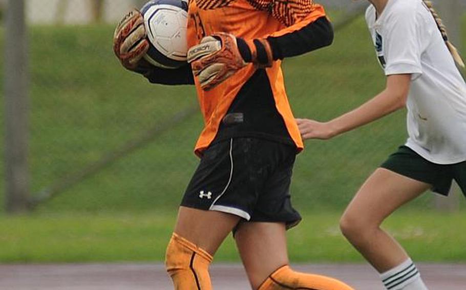 Kubasaki goalkeeper Harleigh Lewis, with ball during last week's Far East Division I Tournament final against American School In Japan. Lewis allowed two regulation goals this season to American players and one more in a penalty-kick shootout. She posted eight shutouts, four by 1-0 scores in Far East alone.