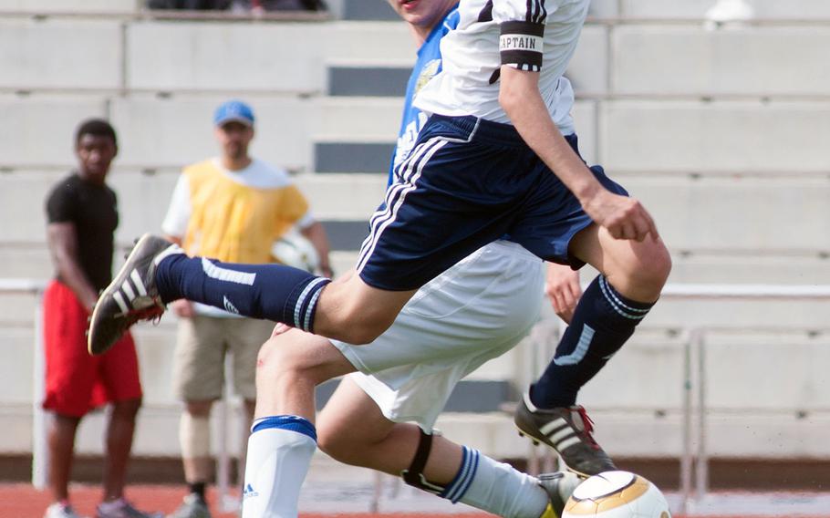 Menwith Hill Mustang Val Evans sweeps by Sigonella fullback Bailey Jones during a Division III semifinal at Kaiserslautern High, May 21, 2014. The Mustangs will be competing in their final soccer championships this month before the school closes at the end of the school year.