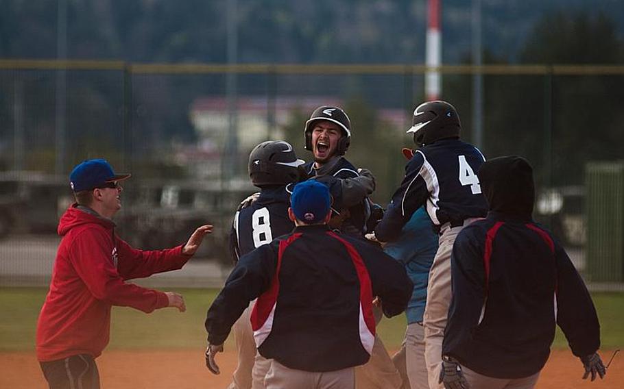 Andrew Grider celebrates with his fellow Barons after smashing a double that brought in the winning run as Bitburg beat the Hohenfels Tigers 12-11 during a doubleheader in Hohenfels, April 18, 2015.