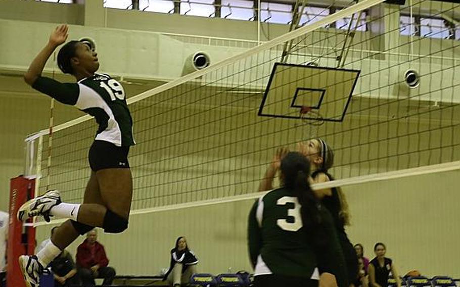 Kubasaki's Kaelyn Francis goes up to spike against ASIJ's Mia Weinland in Thursday's final. Kubasaki won in four sets to capture its first Far East Division I Volleyball Tournament title in school history.