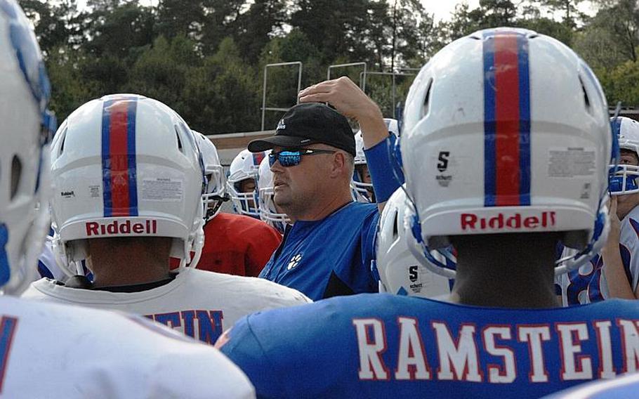 Defensive coordinator Carter Hollenbeck addresses Ramstein players during a preseason practice sessioni at Ramstein Air Base, Germany. Hollenbeck crafted a defense that shut out Wiesbaden 17-0 in the 2014 DODDS-Europe Division I title game.