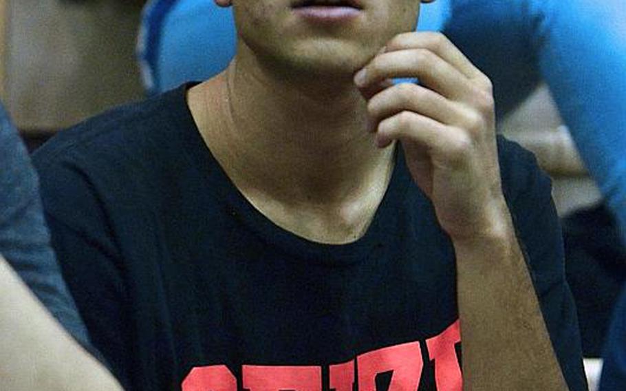 E.J. King senior Rikki Kendall eyes the action while covering a volleyball match at Yokota for his newspaper team during DODDS Pacific Far East Journalism.