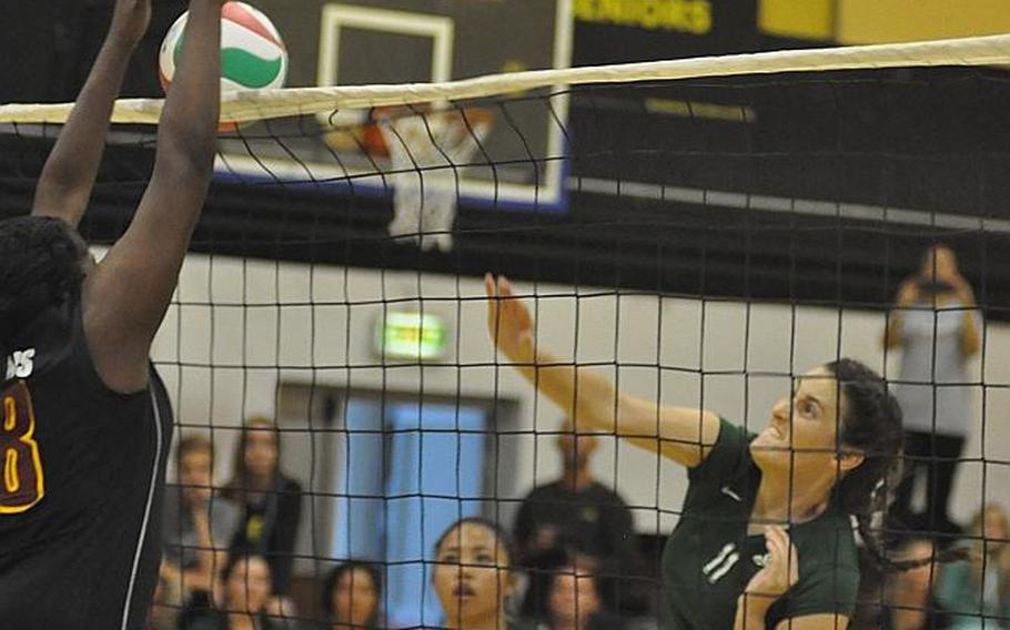 Naples' Angelica Sheils hits the ball into a block from Vilseck's Mahogany Lediju in a September matchup in Vicenza, Italy. Both teams have some work to do if they want to challenge unbeaten defending champion Wiesbaden for this year's title.