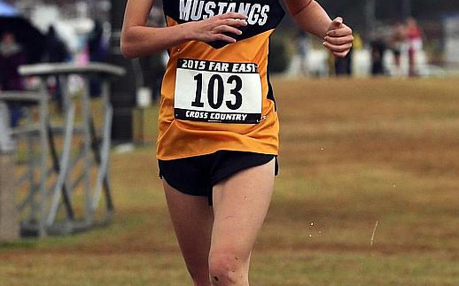 American School In Japan junior Lisa Watanuki crosses the finish line in 20 minutes, 7.31 seconds.