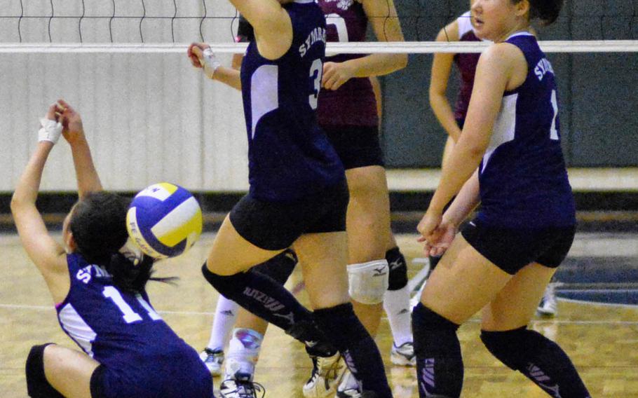 International School of the Sacred Heart's Emu Yoshimura (11), Nina Warita (3) and Yoko Imajo (1) have trouble getting a handle on the ball against Matthew C. Perry during Thursday's championship match in the Far East Division II volleyball tournament. The Symbas won the first title in this tournament in school history, beating the Samurai 27-25, 23-25, 26-24, 25-15.