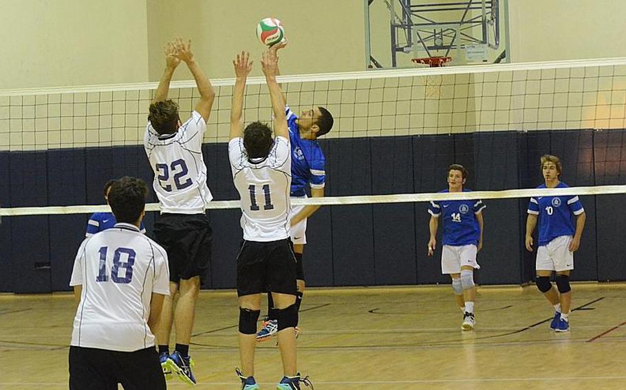 Marymount International's Michele Musilli tips the ball over the hands of two Bahrain defenders Saturday during the 2015 DODDS-Europe boys volleyball championships at Aviano Air Base, Italy.The Falcons beat the Royals, 25-23, 25-19, 25-22.