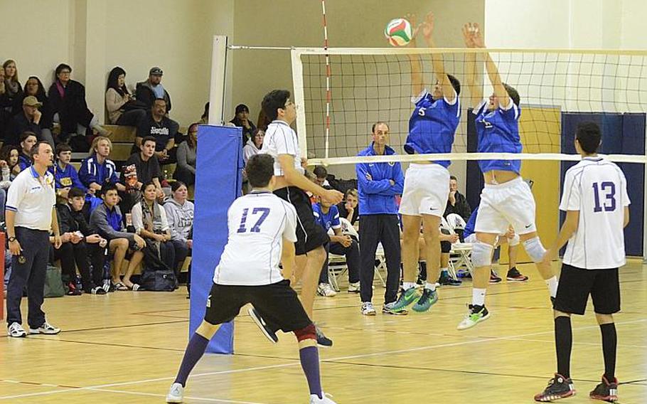 Marymount International's Jean-Luc Putter blocks the spike of Ahmed Buhidma of Bahrain on Saturday during the 2015 DODDS-Europe boys volleyball championship at Aviano Air Base, Italy. The Falcons beat the Royals, 25-23, 25-19, 25-22.