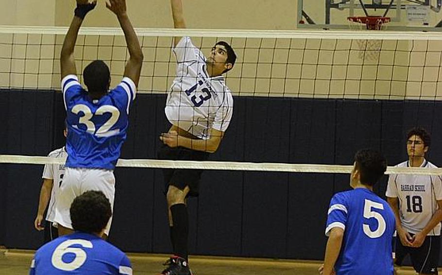 Bahrain's Anas Abed spikes the ball past Marymount International's Lotanna Mba on Saturday during the 2015 DODDS-Europe boys championship match at Aviano Air Base, Italy. The Falcons beat the Royals, 25-23, 25-19, 25-22.