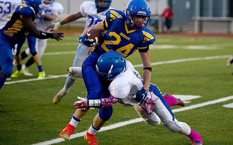 Ansbach Cougar Tyler Benton evades a tackle during the DODDS-Europe Division II football championship at Vogelweh, Germany, on Nov. 7, 2015, en route to a 32-27 victory. Benton was selected as the 2015 Stars and Stripes Europe football Athlete of the Year.