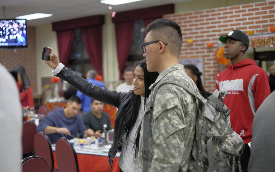 Ultimate Fighting Championship Octagon Girl Red Dela Cruz takes a selfie with a soldier during Thanksgiving dinner Thursday, Nov. 26, 2015, at U.S. Army Garrison Yongsan in Seoul, South Korea. Dela Cruz was among the eight UFC fighters and Octagon Girls who visited the garrison to give thanks to the servicemen and women stationed on the peninsula.