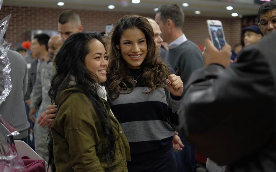 Ultimate Fighting Championship bantamweight Julianna Pen poses with a soldier during Thanksgiving dinner on Thursday, Nov. 26, 2015, at U.S. Army Garrison Yongsan in Seoul, South Korea. Pena was among the eight UFC fighters and Octagon Girls who visited the garrison to give thanks to the servicemen and women stationed on the peninsula.
