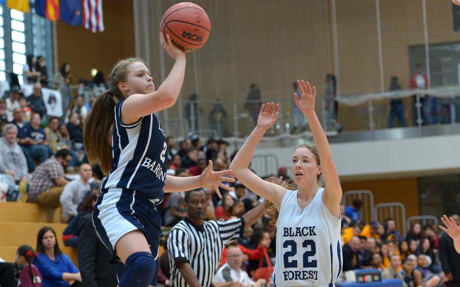 Bit burg's Alexa Landenberger gets past Black Forest Academy's Anna Kragt for a shot in last season's Division II championship game in Wiesbaden, Germany, Saturday Feb. 21, 2015. Bit burg defeated BFA 34-27 for the title.