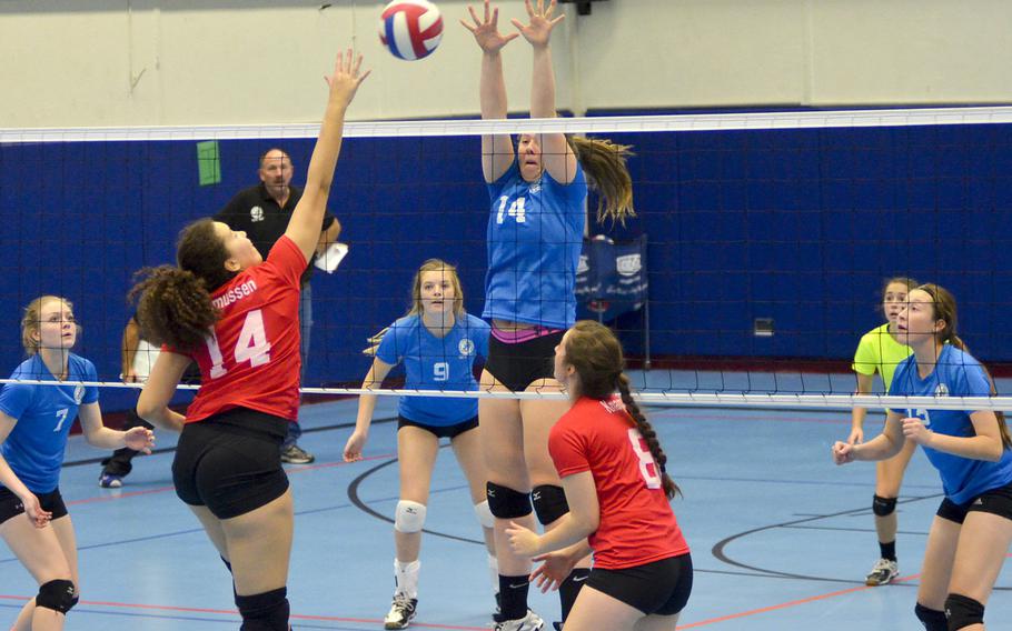 Eslise Rasmussen, a junior middle hitter from Bitburg High School, spikes the ball against Adrianna Lovelace of Vicenza High School during the inaugural DODDS Europe volleyball all star game Saturday, Nov. 14 at Ramstein High School, Germany. The game was an opportunity for the best junior and senior players from across DODDS schools in Europe to play at a high level against their peers one final time.