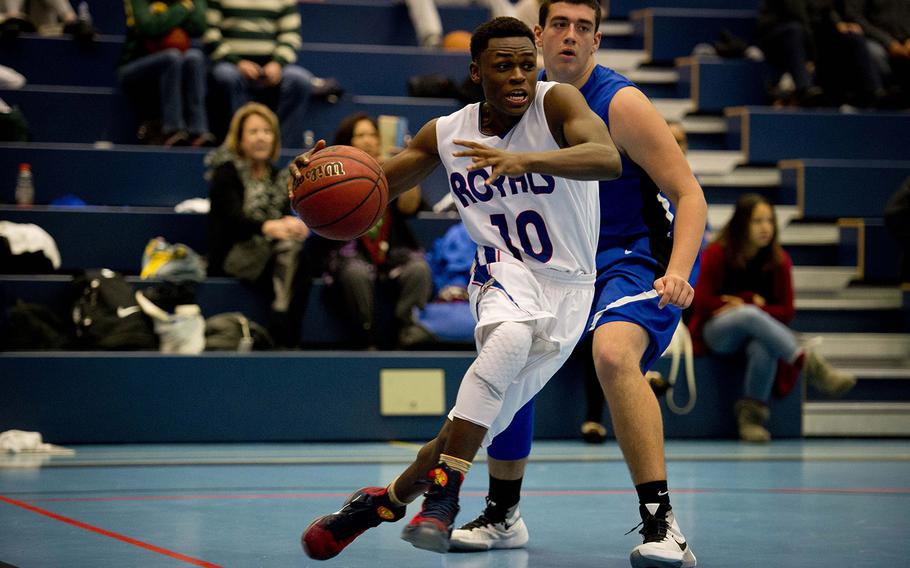 Ramstein's Malik Cannon dribbles around Rota's Andy Drake during the DODDS-Europe holiday tournament at Ramstein Air Base, Germany, on Monday, Dec. 21, 2015. The Royals beat the Admirals 37-24.