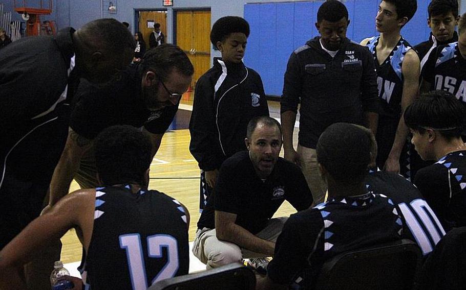 Osan boys coach Morgan Nugent chats it up with his charges during a timeout.