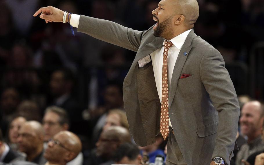 Knicks head coach Derek Fisher talks to his players during the second half Sunday against the Nuggets. Denver defeated the Knicks 101-96, the team’s fifth straight loss. New York fired Fisher on Monday. Seth Wenig/AP