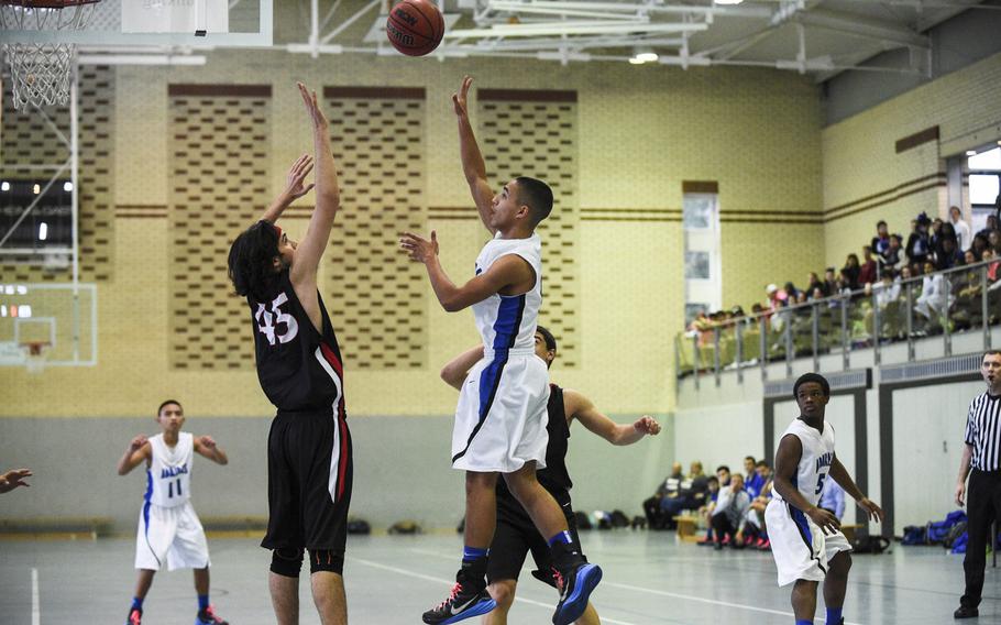 Rota's Jashaun Garrison floats the ball over AOSR's Francesco Gristina at last year's DODDS-Europe basketball tournament at the German Police Academy at Mainz-Kastel, Germany,Thursday, Feb. 19, 2015. This year's championships will be held  at two locations in Kaiserslautern, at McCully Barracks in Wackernheim and at Wiesbaden's high school and Clay Kaserne fitness center.