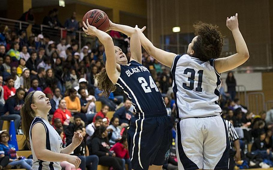 Black Forest Academy's Cailynn Campbell gets a shot past Bitburg's Elise Rasmussen during the DODDS-Europe Division II championship game in Wiesbaden, Germany, Saturday, Feb. 27, 2016. Black Forest Academy beat Bitburg 25-16 to win the title.
