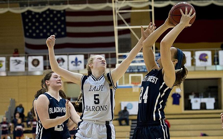 Black Forest Academy's Cailynn Campbell takes a shot over Bitburg's Baileigh McFall during the DODDS-Europe Division II championship game in Wiesbaden, Germany, Saturday, Feb. 27, 2016. Black Forest Academy beat Bitburg 25-16 to win the title.