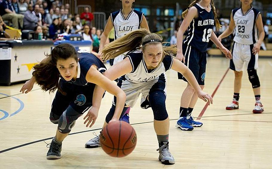 Bitburg's Alexa Landenberger, right, and Black Forest Academy's Naomi Ruegg go for the ball during the DODDS-Europe Division II championship game in Wiesbaden, Germany, Saturday, Feb. 27, 2016. Bitburg lost the game 25-16.