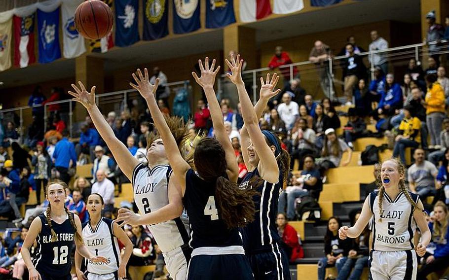 Bitburg's Alexa Landenberger shoots around the Black Forest Academy defense during the DODDS-Europe Division II championship game in Wiesbaden, Germany, Saturday, Feb. 27, 2016. Bitburg lost the game 25-16.