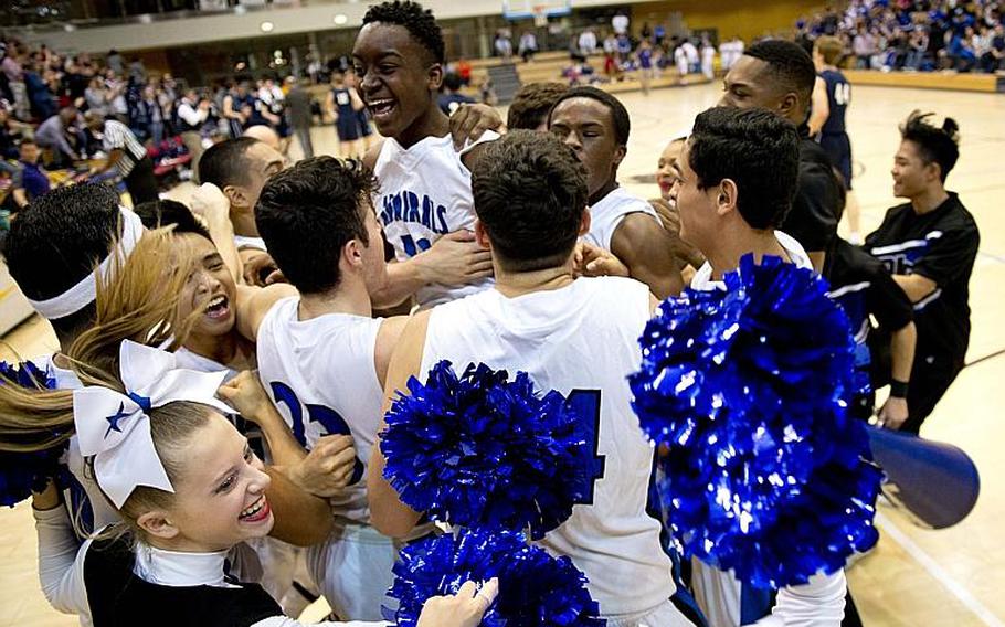 The Rota Admirals celebrate after winning the DODDS-Europe Division II championship game in Wiesbaden, Germany, Saturday, Feb. 27, 2016. The Admirals defeated the Black Forest Academy Falcons 71-43 to win the title. 