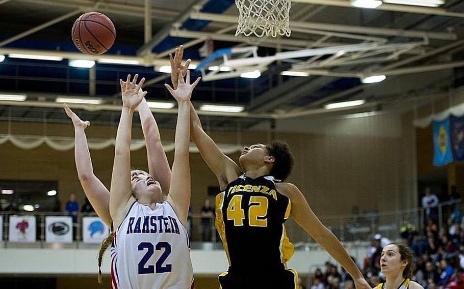 Vicenza's Jordan Wakefield, right, and Ramstein's Lindsey Breton go for a rebound during the DODDS-Europe Division I championship game in Wiesbaden, Germany, Saturday, Feb. 27, 2016. Vicenza lost to Ramstein in overtime 49-46. 